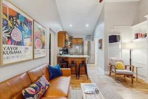 a living room with a couch and a kitchen at Arrowhead Resort - Stylish Retro Escape in Saugatuck