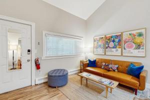 a living room with a couch and a table at Arrowhead Resort - Stylish Retro Escape in Saugatuck