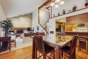 a kitchen and living room with a table and chairs at Ski & Tee Boyne Highlands Townhouse in Harbor Springs