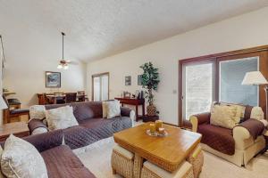 a living room with a couch and a table at Ski & Tee Boyne Highlands Townhouse in Harbor Springs