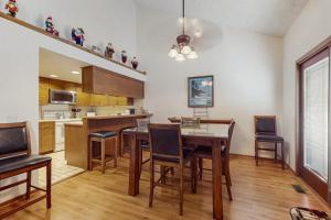 a kitchen with a table and chairs in a room at Ski & Tee Boyne Highlands Townhouse in Harbor Springs