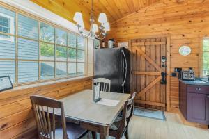 a dining room with a table and a refrigerator at Peterson Mill in Saugatuck