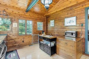 a kitchen with wooden walls and a counter with a microwave at Peterson Mill in Saugatuck +15 photos