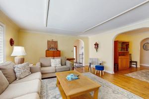 a living room with a couch and a table at Wine Down Cottage in Union Pier