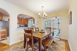 a kitchen and dining room with a wooden table and chairs at Wine Down Cottage in Union Pier