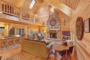 a living room with a couch and a fireplace at Kingfisher Cove Cabin 2 in Saugatuck
