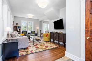 a living room with a couch and a tv at Three Oaks Retreat in Three Oaks
