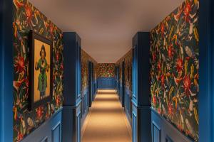 a hallway with blue walls and colorful wallpaper at Hotel Casa Canita in Miami Beach