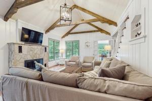 a living room with a large couch and a fireplace at Chalet May in Michiana