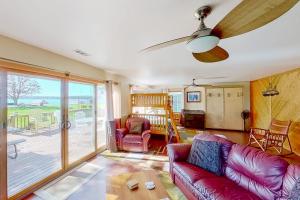 a living room with a couch and a table at The Summer House in Onekama