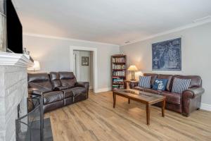 a living room with leather furniture and a fireplace at Serenity Now in Saugatuck