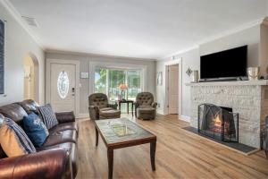 a living room with a couch and a fireplace at Serenity Now in Saugatuck