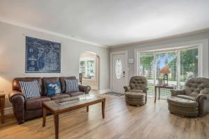 a living room with a couch and two chairs and a table at Serenity Now in Saugatuck