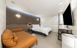 a hotel room with a bed and a couch at Seocho JS Hotel in Seoul