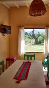 a dining room with a table and a window at La Celina Casas de Campo in Nono