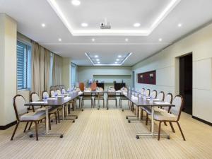 a conference room with tables and chairs and a podium at ibis Muscat in Muscat