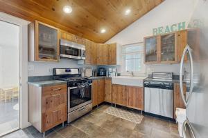 a kitchen with wooden cabinets and a stove top oven at Fresh Pond Chateau in Oak Bluffs