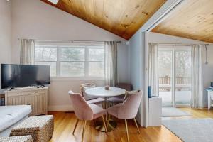 a living room with a table and chairs and a couch at Fresh Pond Chateau in Oak Bluffs