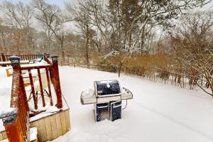 a tv sitting on a trash can in the snow at Fresh Pond Chateau in Oak Bluffs