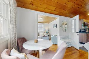 a living room with a white table and chairs at Fresh Pond Chateau in Oak Bluffs