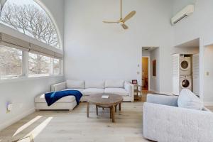 a living room with a couch and a table at Fairway Bliss at Ocean Edge in Brewster