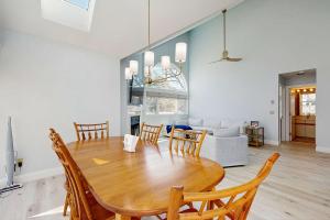 a dining room and living room with a table and chairs at Fairway Bliss at Ocean Edge in Brewster