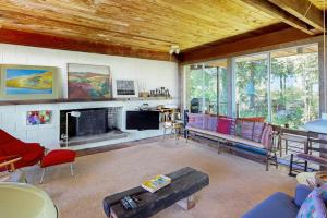 a living room filled with furniture and a fireplace at The Eliot Noyes in Chilmark