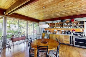 a kitchen and dining room with a wooden ceiling at The Eliot Noyes in Chilmark