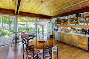 a kitchen and dining room with a table and chairs at The Eliot Noyes in Chilmark