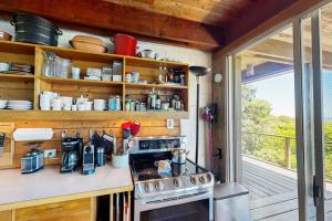 a small kitchen with a stove and a window at The Eliot Noyes in Chilmark +23 photos