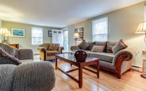 a living room with two couches and a coffee table at Island Sanctuary in Oak Bluffs