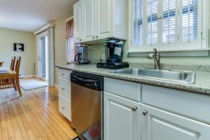 a kitchen with a sink and a dishwasher at Island Sanctuary in Oak Bluffs +18 photos