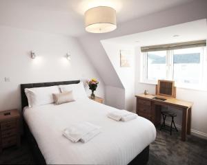 Ένα ή περισσότερα κρεβάτια σε δωμάτιο στο Austens Apartments