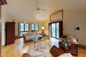 a living room with a couch and a table at Island Getaway in Oak Bluffs