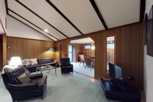 a living room with a couch and a tv at Island Getaway in Oak Bluffs
