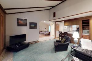 a living room with a couch and a television at Island Getaway in Oak Bluffs
