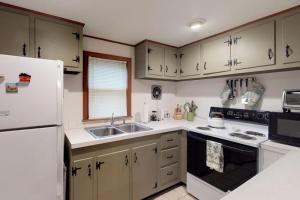 a kitchen with a white refrigerator and a sink at Island Getaway in Oak Bluffs