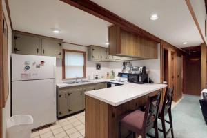 a kitchen with a white refrigerator and a counter at Island Getaway in Oak Bluffs +28 photos