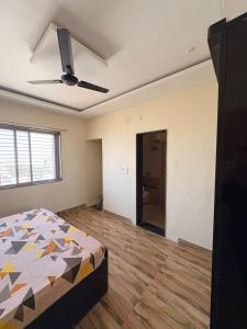 a bedroom with a bed and a ceiling fan at Cloud Nine in Boria Kalān