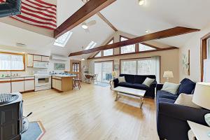 a large living room with an american flag on the ceiling at Harbor Cove Cottage in Edgartown