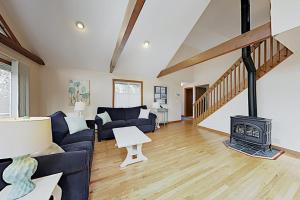 a living room with a couch and a wood stove at Harbor Cove Cottage in Edgartown +16 photos