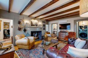 a living room with leather furniture and a fireplace at The Groggy Anchor in Provincetown