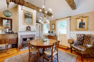a dining room with a table and a fireplace at The Groggy Anchor in Provincetown