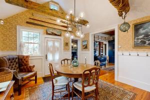 a dining room and living room with a table and chairs at The Groggy Anchor in Provincetown +19 photos