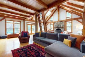 a living room with a blue couch and a fireplace at Bumps River Bungalow in Centerville