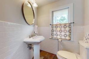 a bathroom with a sink and a toilet and a mirror at Bumps River Bungalow in Centerville +19 photos