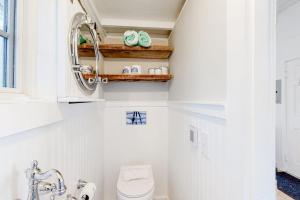 a bathroom with a toilet and a sink at Long Point Getaway in Provincetown