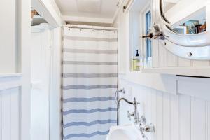 a bathroom with a sink and a shower curtain at Long Point Getaway in Provincetown