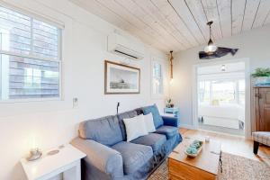 a living room with a blue couch and a table at Long Point Getaway in Provincetown +15 photos