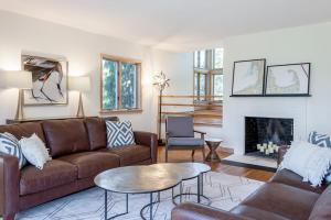 a living room with a couch and a fireplace at Blackfish Bungalow in Wellfleet